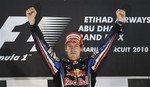 Red Bull driver Sebastian Vettel of Germany celebrates on the podium after becoming 2010 Formula One World champion and winning the Emirates Formula One Grand Prix at the Yas Marina racetrack, in Abu Dhabi, United Arab Emirates, Sunday, Nov.14, 2010