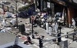 Investigators in haz-mat suits examine the scene of the second bombing on Boylston Street in Boston Tuesday, April 16, 2013 near the finish line of the 2013 Boston Marathon, a day after two blasts killed three and injured over 170 people.