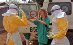 In this photo provide by MSF, Medecins Sans Frontieres (Doctors without Borders), taken on Friday, March 28, 2014, healthcare workers from the organisation, react, as they prepare isolation and treatment areas for their Ebola, hemorrhagic fever operations, in Gueckedou, Guinea.