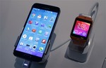 A Samsung Galaxy S5 smartphone, left, and a Samsung Gear 2 are displayed at the Samsung Galaxy Studio, in New York, Monday, Feb. 24, 2014.