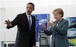 Democratic presidential candidate Sen. Barack Obama, D-Ill., left, waves to the media as he greets with German Chancellor Angela Merkel in Berlin, Thursday, July 24, 200