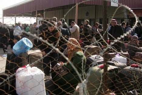 Palestinians, hoping to cross into Egypt, wait at the Rafah crossing between Egypt and the southern Gaza Strip on March 29, 2014. Egyptian authorities partially reopened Rafah border crossing, Gaza's main window to the world, on Saturday for three days after 50 days of closure. its Islamist rulers Hamas said. Photo by Ahmed Deeb / WN