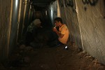 File - Palestinian workers in the tunnel along the border between the Gaza Strip and Egypt, in Rafah, southern Gaza Strip.