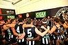 Magpie joy: Collingwood players sing the song. 