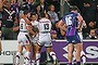 Shaun Johnson of the Warriors is congratulated by his teammates after scoring against the Melbourne Storm.
