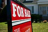 A for sale sign stands outside of a home in Princeton, Illinois, U.S., on Wednesday, May 30, 2012. The number of Americans signing contracts to buy previously-owned homes fell in April by the most in a year, indicating the U.S. housing recovery remains uneven. Photographer: Daniel Acker/Bloomberg