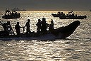 South Korean rescue workers operate around the area where the capsized passenger ship Sewol sank during a rescue operation in Jindo April 23, 2014. South Korean divers swam though dark, cold waters into a sunken ferry on Wednesday, feeling for children's bodies with their hands in a maze of cabins, corridors and upturned decks as they searched for hundreds of missing. REUTERS/Yonhap (SOUTH KOREA - Tags: DISASTER MARITIME) ATTENTION EDITORS - THIS IMAGE WAS PROVIDED BY A THIRD PARTY. FOR EDITORIAL USE ONLY. NOT FOR SALE FOR MARKETING OR ADVERTISING CAMPAIGNS. THIS PICTURE IS DISTRIBUTED EXACTLY AS RECEIVED BY REUTERS, AS A SERVICE TO CLIENTS. NO SALES. NO ARCHIVES. SOUTH KOREA OUT. NO COMMERCIAL OR EDITORIAL SALES IN SOUTH KOREA