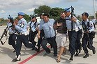 Indonesian military officers haul Matt Christopher Lockley away.