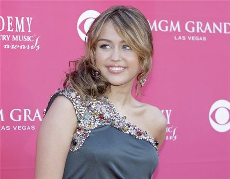 Miley Cyrus arrives at the 44th Annual Academy of Country Music Awards in Las Vegas on Sunday, April 5, 2009.