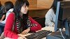 student using a computer in the library