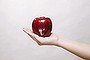 Hand holding a red apple