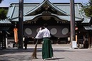 A shrine attendant cleans at the Yasukuni Shrine before its Annual Spring Festival in Tokyo April 22, 2014. Japanese Chief Cabinet Secretary Yoshihide Suga said on Tuesday that the Japanese government should not interfere if a lawmaker pays a visit to Tokyo's Yasukuni Shrine, seen by critics as a symbol of Japan's past militarism, as an individual. REUTERS/Yuya Shino (JAPAN - Tags: POLITICS RELIGION)