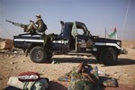 A former rebel fighter rests at the northern gate of Bani Walid, Libya, Saturday, Sept. 17, 2011.