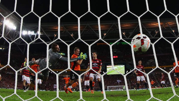 Besart Berisha of the Roar heads his shot past Wanderers goalkeeper Ante Covic.