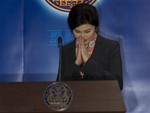 Thailand's Prime Minister Yingluck Shinawatra gives a Thai traditional greeting gesture of "wai" during a press conference in Bangkok, Thailand Wednesday, May 7, 2014.