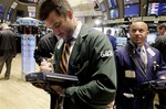 In this Aug, 2, 2010 photo, traders Luke Dalton, left, and Robert Arcero work on the floor of the New York Stock Exchange. Stock futures are trading in a tight range Tuesday, Aug. 3, as investors paused following a big start to August. (AP Photo/Richard Drew)