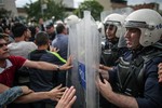 Riot police try to stop protesters who were attacking the Soma offices of Prime Minister Recep Tayyip Erdogan's Justice and Development Party during his visit to the coal mine in Soma, Turkey, Wednesday, May 14, 2014.