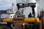 File - Operators aboard the Australian navy vessel ADF Ocean Shield in the Indian Ocean move U.S. Navy's Bluefin-21 into position for deployment. Using side scan sonar, Bluefin will descend to a depth of between 4,000 and 4,500 meters, approximately 35 meters above the ocean floor to spend up to 16 hours at this depth collecting data, 14 April, 2014.