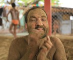 Indian wrestler use muddy soil on his face  after fight practice  in the wrestling club on the shore of the Hoogly River in Kolkata on Sunday morning 05 May 2013