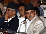 Nepal's Prime Minister Puspa Kamal Dahal Prachanda, right, and former Prime Minister Sher Bahadur Deuba look on during an address by President Ram Baran Yadav, unseen, to the parliament in Katmandu, Nepal, Wednesday, Sept. 10, 2008. A government policy document read in parliament Wednesday by Yadav said the former communist rebel fighters living in camps would be "rehabilitated" and become part of national security forces, but it did not give specific details.