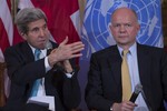 British Foreign Secretary William Hague listens at right as Secretary of State John Kerry speaks at the State Department in Washington, Tuesday, Feb. 25, 2014, during a discussion on ending sexual violence and conflict in war. The US and Britain are rejecting suggestions that the ouster of Ukraine's pro-Russian president is symbolic of a Cold War-era East-West divide. Kerry and Hague both disputed on Tuesday the idea that the situation in Ukraine is a "zero-sum game," or one in which one sphere of influence wins at the expense of the other. And each urged Russia to work with the West in helping the Ukrainian people peacefully achieve their democratic aspirations.