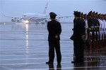 Officers of an honor guard look on as the plane with Russia's President Vladimir Putin