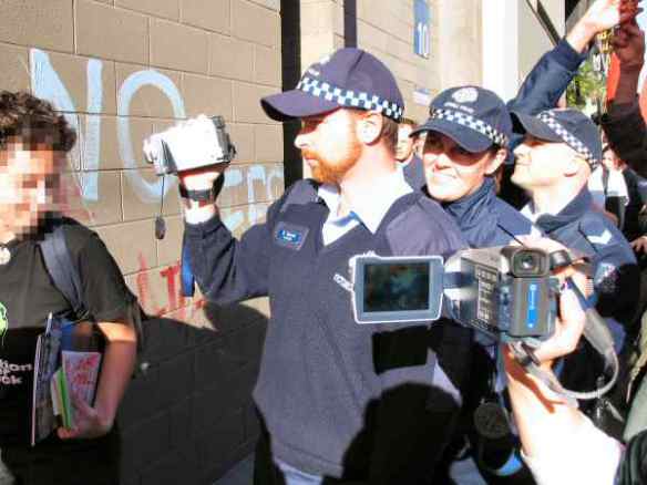 Police with camcorder being filmed themselves