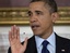 President Barack Obama tries to wave away a fly buzzing around his head as he announces in the State Dining Room of the White House in Washington