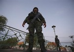 Thai soldiers stand guard in front of Marble Temple in Bangkok, Thailand, Friday, May 23, 2014 after Thai military staged a coup. Thailand's new military junta has announced that it has suspended the country's constitution.