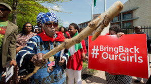 Mia Kuumba, of the District of Columbia, brandishes a wooden stick during a rally in front of the Nigerian embassy in northwest Washington, Tuesday, May 6, 2014, protesting the kidnapping of nearly 300 teenage schoolgirls, abducted from a school in the remote northeast of Nigeria three weeks ago. (AP Photo/Manuel Balce Ceneta)