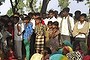 Indian villagers gather around the bodies of two teenage sisters hanging from a tree in Katra village in Uttar Pradesh state, India. The victims' families allege that local police were shielding the attackers.