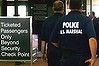 Armed U.S.  Marshals patrol a security checkpoint at Logan Airport in Boston, Massachusetts.