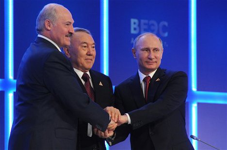 From right, Russian President Vladimir Putin, Kazakh President Nursultan Nazarbayev and Belarusian President, Alexander Lukashenko shake hands after signing an agreement to create the Eurasian Economic Union in Astana, Kazakhstan, Thursday, May 29, 2014