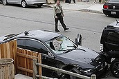 A Santa Barbara County deputy sheriff looks at the black BMW sedan driven by a drive-by shooter on Saturday, May 24, 2014, in Isla Vista, Calif. The shooter went on a rampage near a Santa Barbara university campus that left seven people dead, including the attacker, and others wounded, authorities said Saturday. (AP Photo/Jae C. Hong)