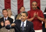 President Barack Obama gestures as he speaks during a town hall meeting at Broughton High School in Raleigh, N.C., Wednesday, July 29, 2009.