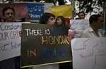 Members of Pakistan's civil society hold banners during a protest to condemn the killing of pregnant woman Farzana Parveen