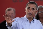 President Barack Obama gestures while speaking at the Theodore Staging Area in Theodore, Ala., Monday, June 14, 2010. It is Obama's third trip to the Gulf coast following the Deepwater Horizon disaster.