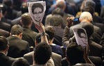 File - Participants hold up images of former NSA analyst Edward Snowden during the opening ceremony of NETmundial, a major conference on the future of Internet governance in Sao Paulo, Brazil, Wednesday, April 23, 2014.