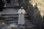 Pope Francis prays at the holy water as he visits the Bethany beyond the Jordan, which many believe is the traditional site of Jesus' baptism, in South Shuna, west of Amman, Jordan, Saturday, May 24, 2014. Pope Francis called on Saturday for an "urgent" end to the Syrian civil war and lamented the refugee crisis it has spawned as he opened a three-day trip to the Middle East. Francis was accompanied by King Abdullah II of Jordan, Queen Rania , Crown Prince Hussein and Prince Ghazi bin Mohammed.