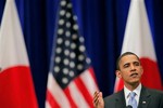 U.S. President Barack Obama gestures as he delivers a speech at a hall in Tokyo Saturday, Nov. 14, 2009. Obama said in the speech that he welcomes a robust China on the world scene, but he cautioned that all nations must respect human rights, including religious freedoms.