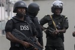 In this file photo taken, Monday, Jan. 30, 2012 file photo, Nigeria secret service officers stand guard, during a court hearing in Lagos, Nigeria.