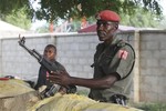 In this Wednesday, Sept. 28, 2011 photo, police officers armed with AK-47 rifles stand guard at sandbagged bunkers along a major road in Maiduguri, Nigeria. The radical sect Boko Haram, which in August 2011 bombed the United Nations headquarters in Nigeria, is the gravest security threat to Africa's most populous nation and is gaining prominence