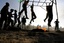 A Palestinian boys take part in a military-style exercise during a summer camp organized by the Hamas movement in Rafah in the southern Gaza Strip on June 9, 2014. Thousands of elementary school students in the Gaza Strip are going to Hamas summer camps, in which they take part in recreational activities and a range of simulated military exercises. Photo by Ahmed Deeb / WN