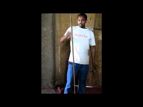 Our guide explaining the sistrum (senasel), the prayer staff (maqwamiya) and kebero drum.