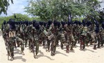 File - In this photo taken Sunday, Sept. 5, 2010, hard-line Islamist Al Shabab fighters conduct military exercises in northern Mogadishu, Somalia.