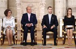 Spain's Queen Sofia, left sits with King Juan Carlos, 2nd left, Spanish Crown Prince Felipe, 3rd left and Princess Letizia before signing an abdication law during a ceremony at the Royal Palace in Madrid