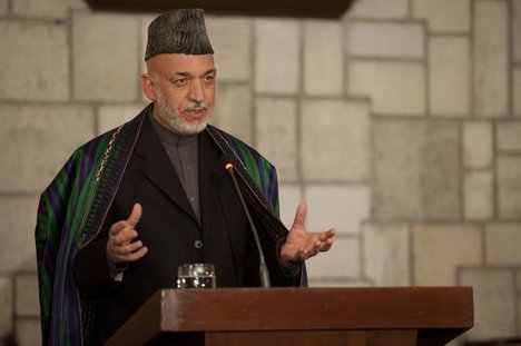 File - Afghan President Hamid Karzai speaks during a press conference with U.S. Secretary of Defense Leon E. Panetta in Kabul, Afghanistan, Dec. 14, 2011.