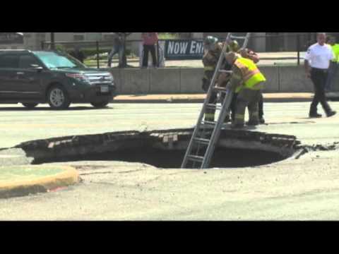 Raw: Woman Rescued After Driving Into Sinkhole