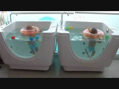 Triplets' first swimming lesson