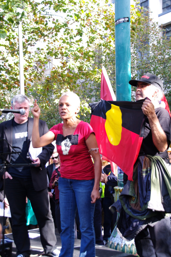Vivian Malo in front of Aboriginal flag